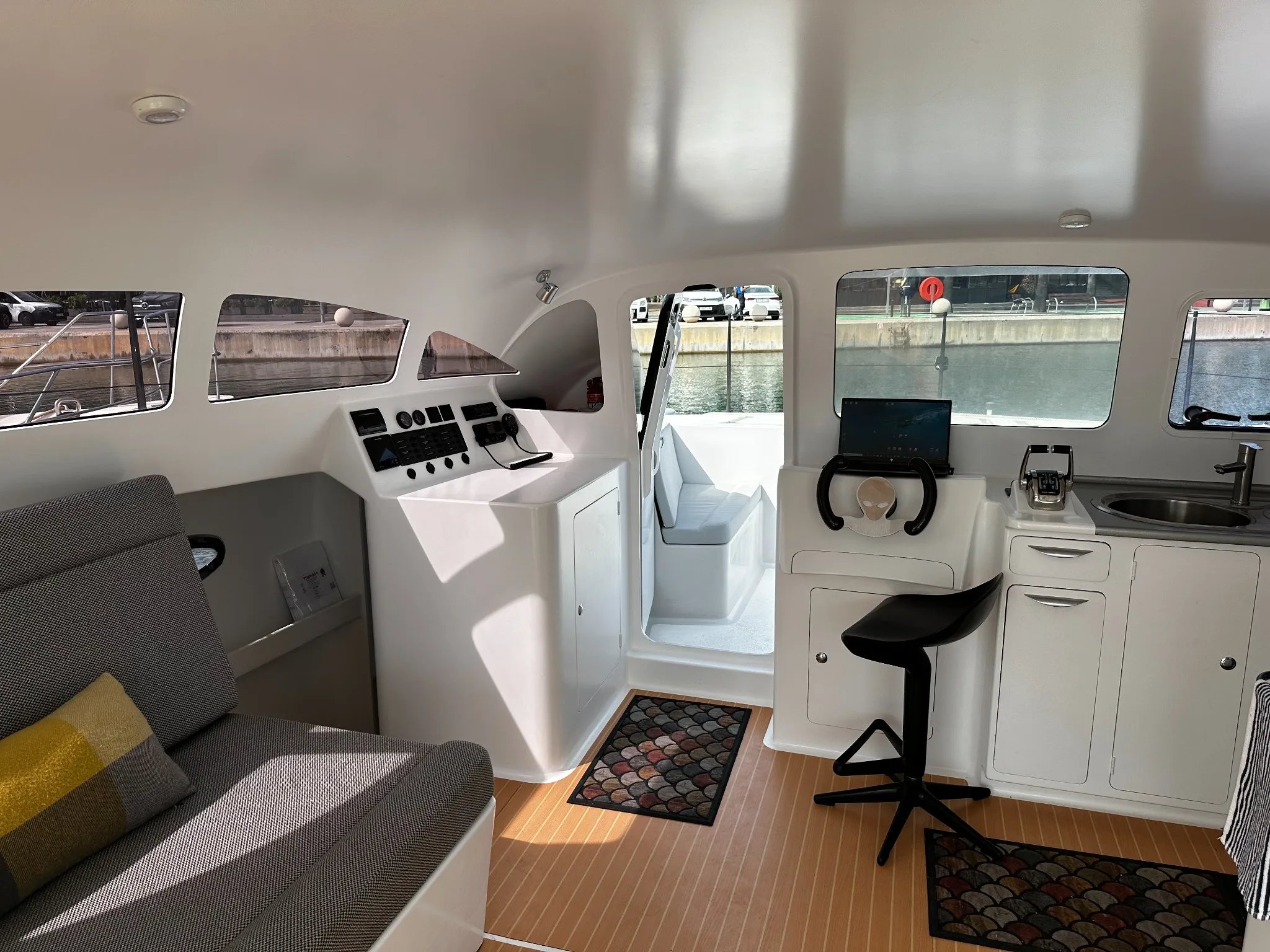 Interior of the Earthling E40 showing the helm station, compact galley and saloon seating.