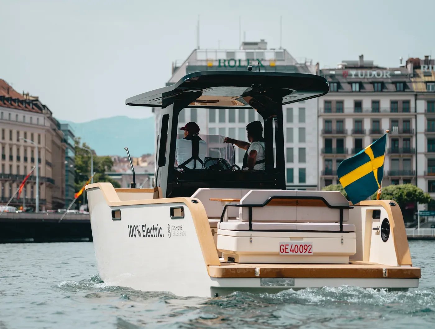 Stern view of the X Shore Eelex 8000 cruising through an urban harbour