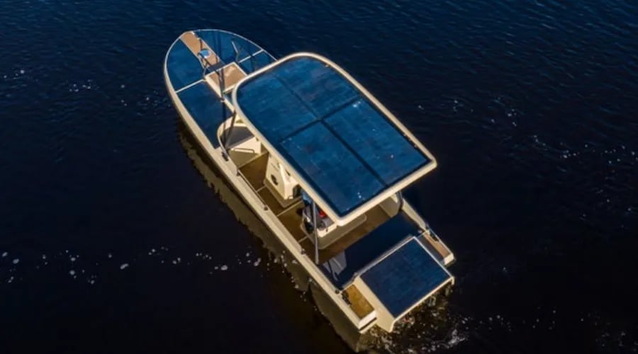 Aerial view of the Elvene Amber showing the large integrated solar roof and open deck layout.