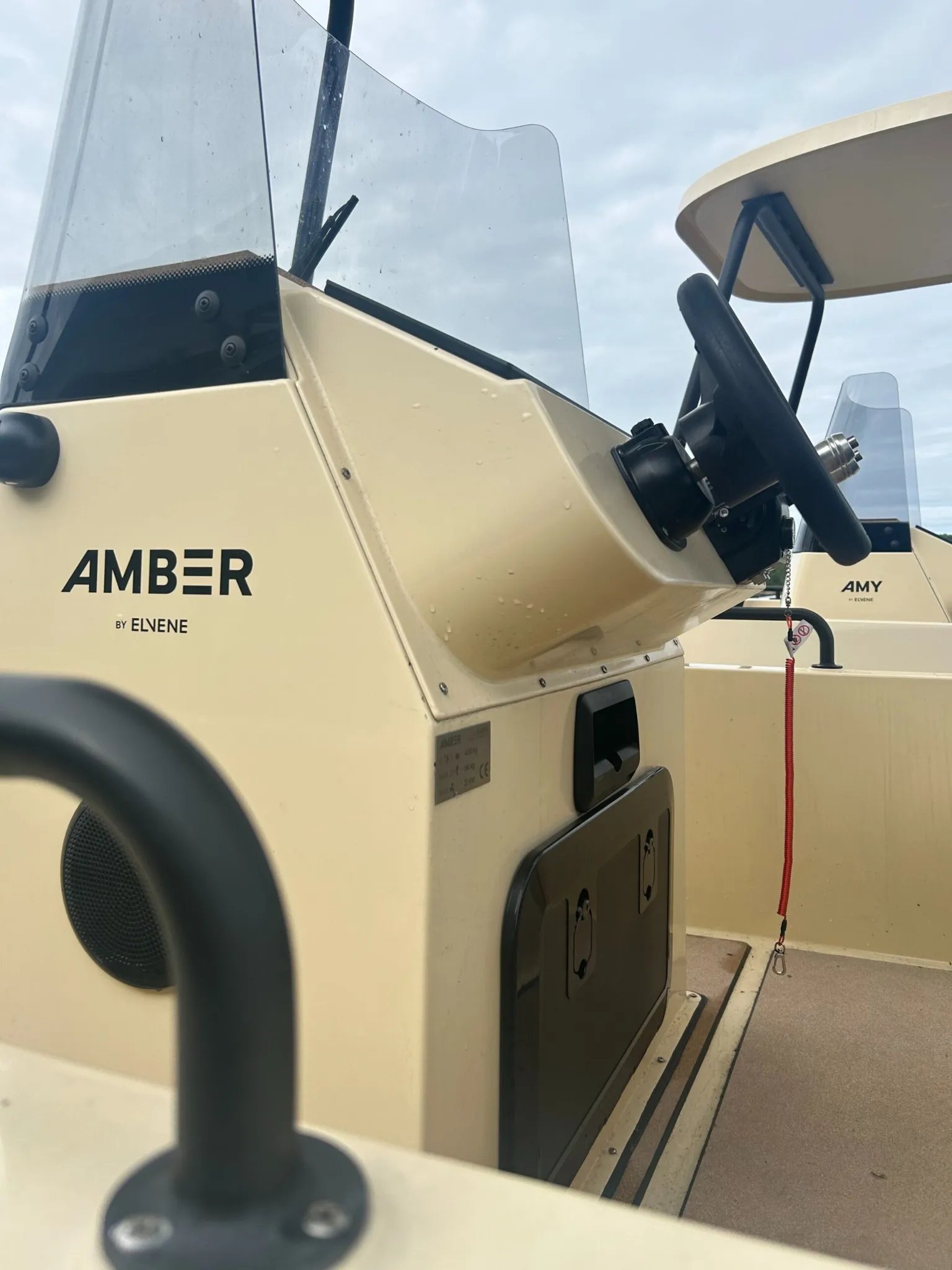 Close-up of the Elvene Amber helm console with steering wheel, windscreen and model branding.