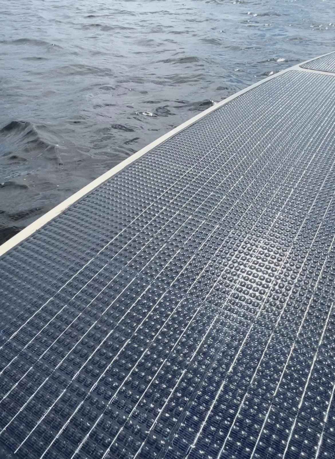 View across the Elvene Amber solar deck panels towards open water.