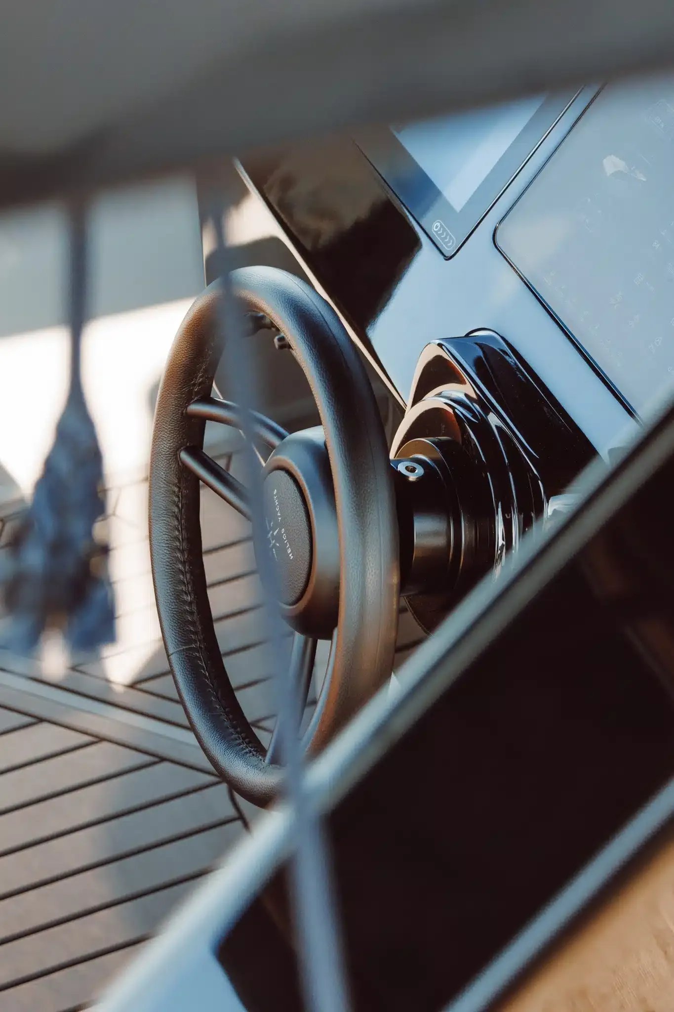 Steering wheel, throttle and digital displays at the helm of the Helios Omega electric boat.