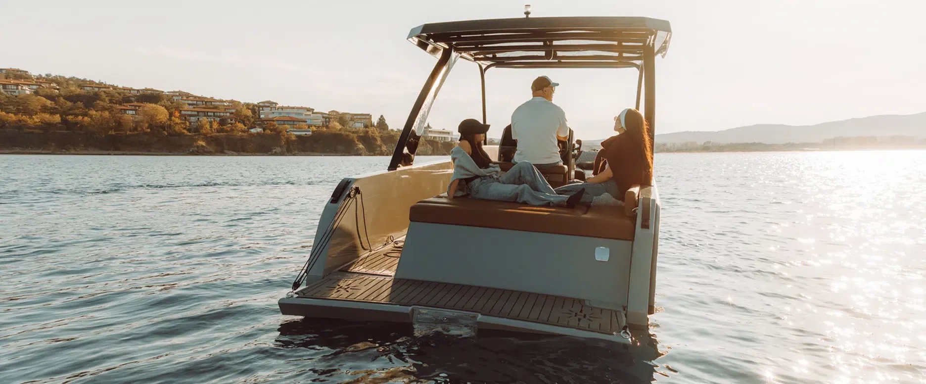 A Helios Omega electric boat with three people on board.
