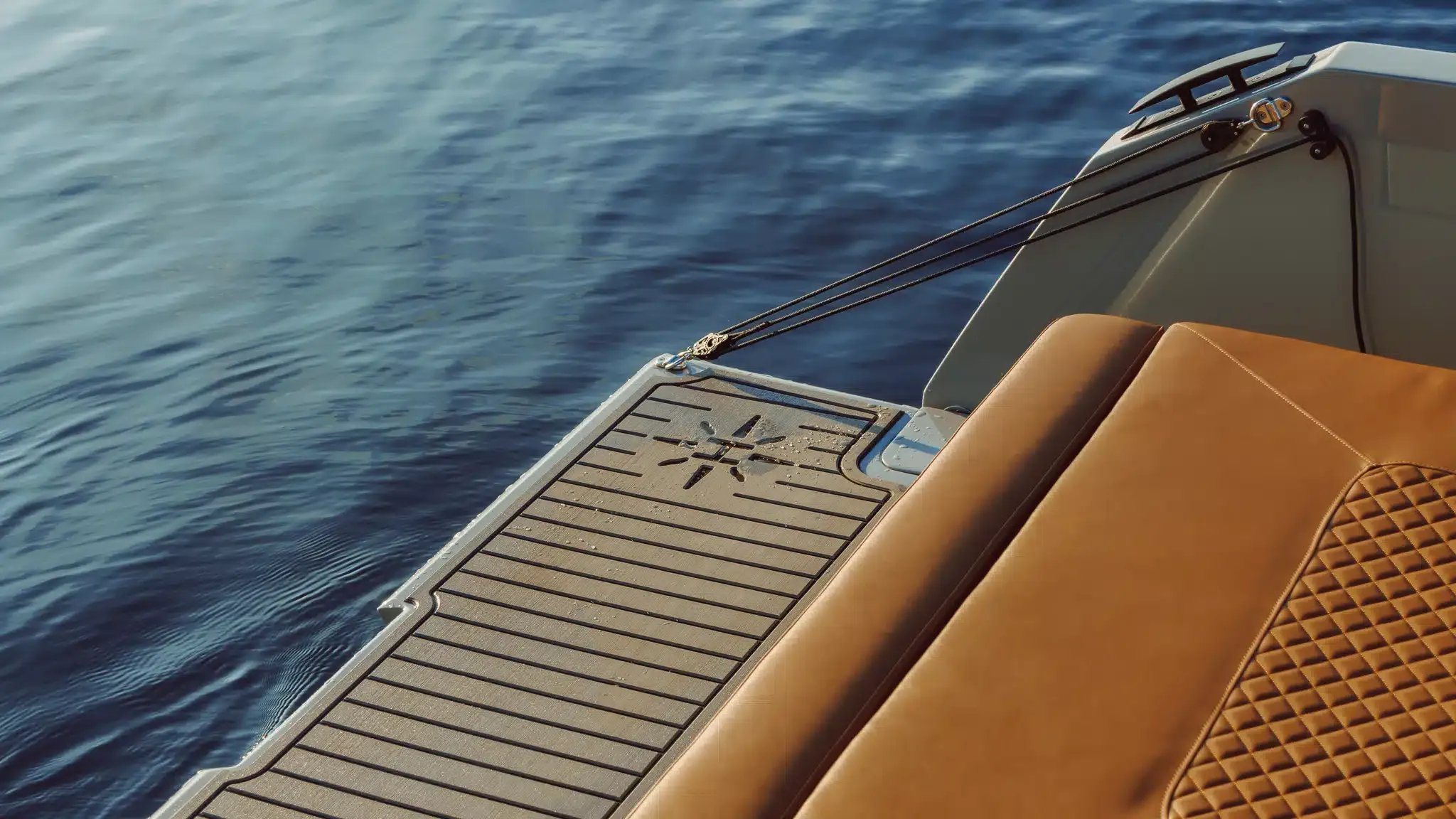 A boat with a brown seat on the back.