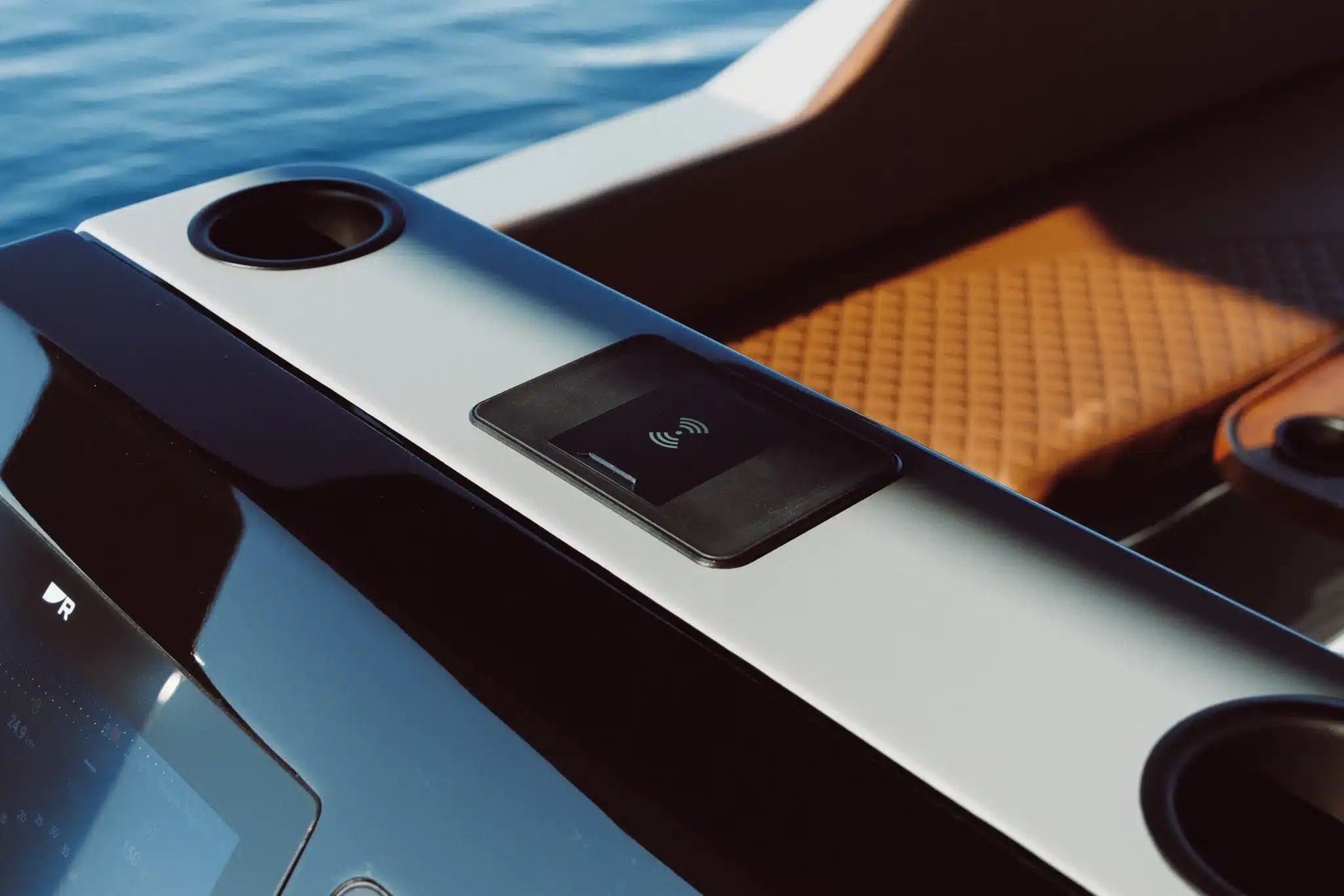 Wireless phone charging pad and cup holders aboard the Helios Omega electric boat.