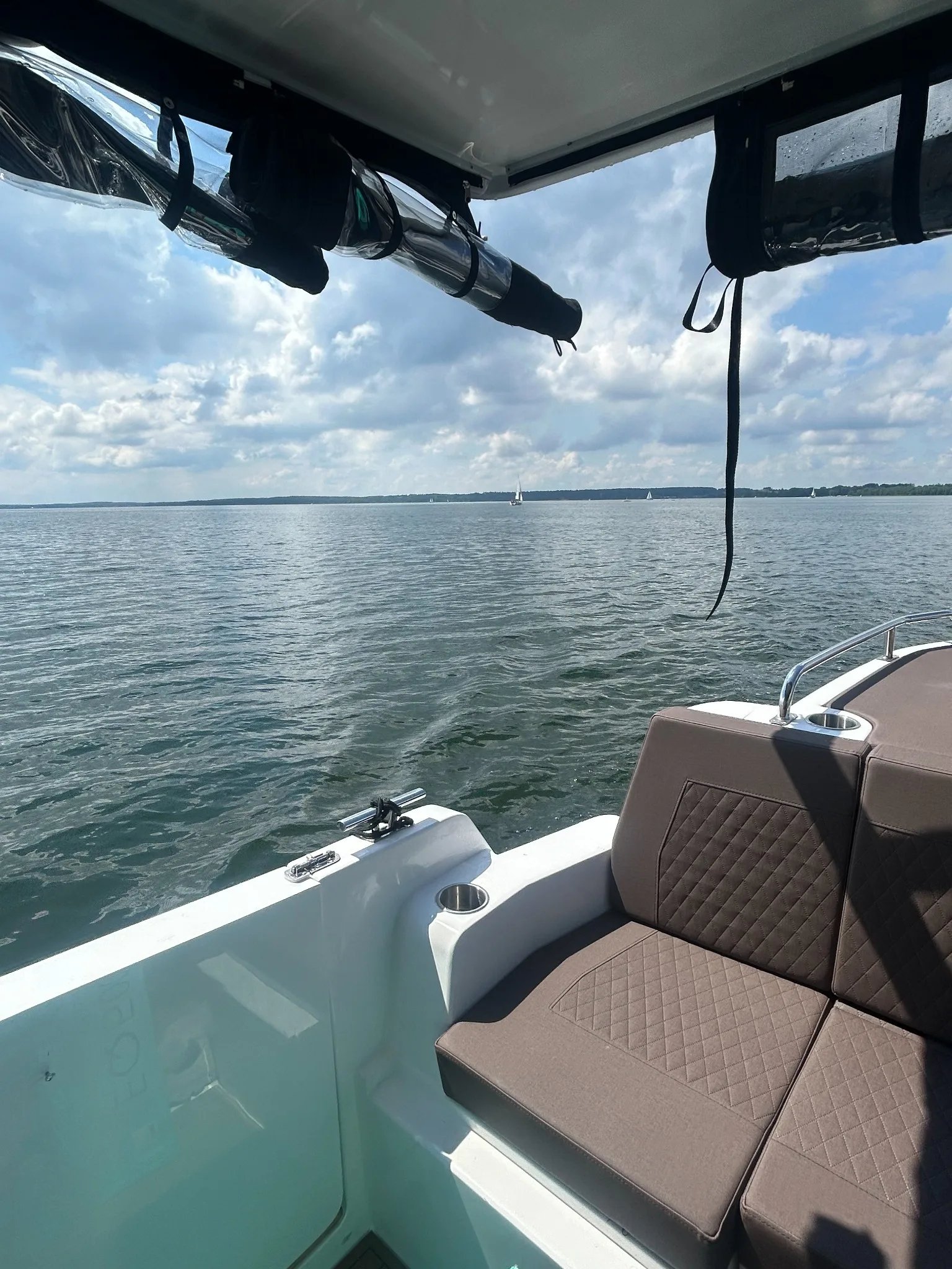 Aft cockpit seating area of the Lamdo eLY30+ overlooking the water.