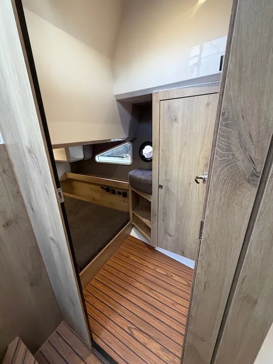 A boat with a wooden interior and a window.