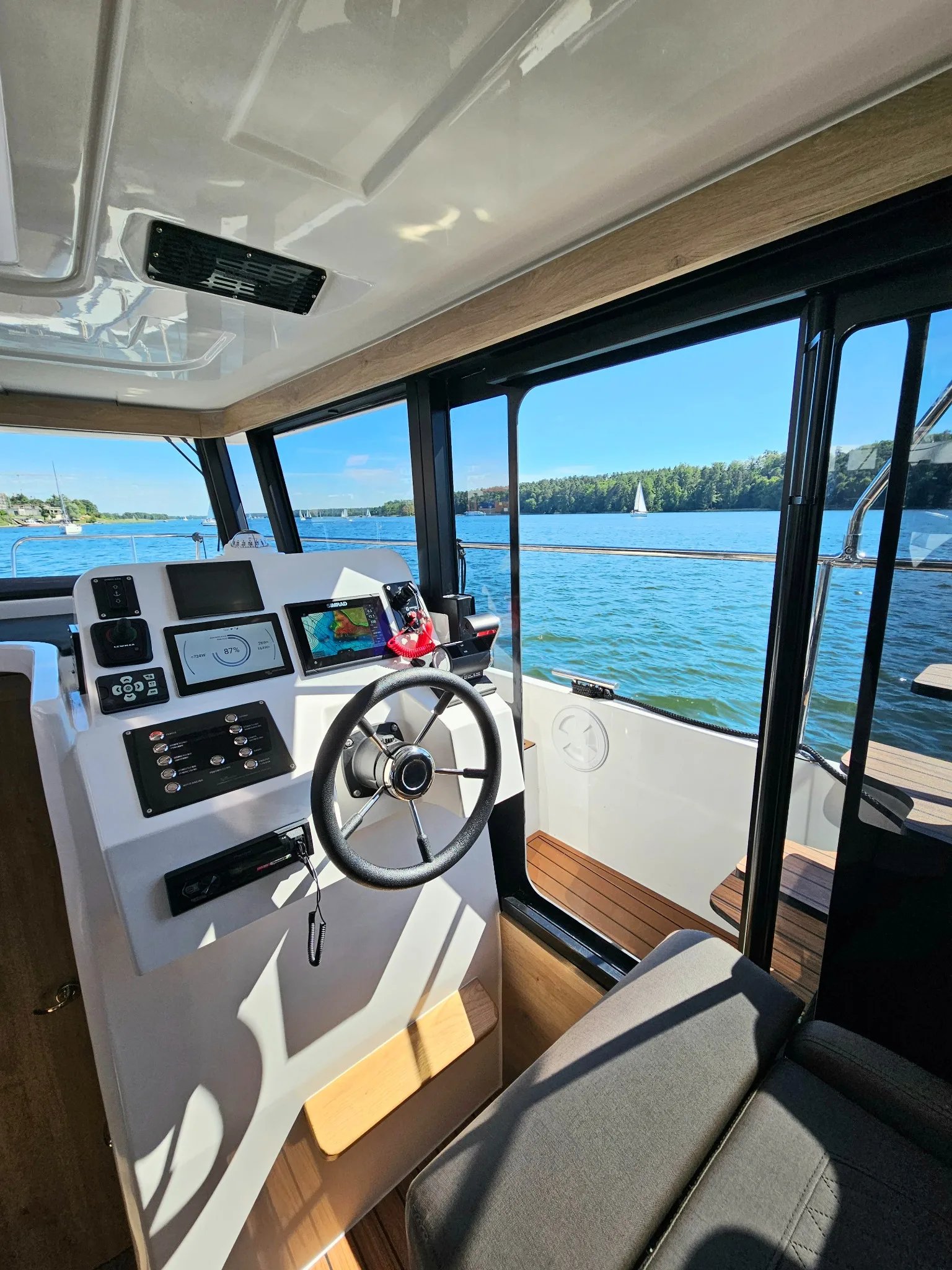 Helm station of the Lamdo eLY30+ with steering wheel, navigation displays and panoramic visibility.