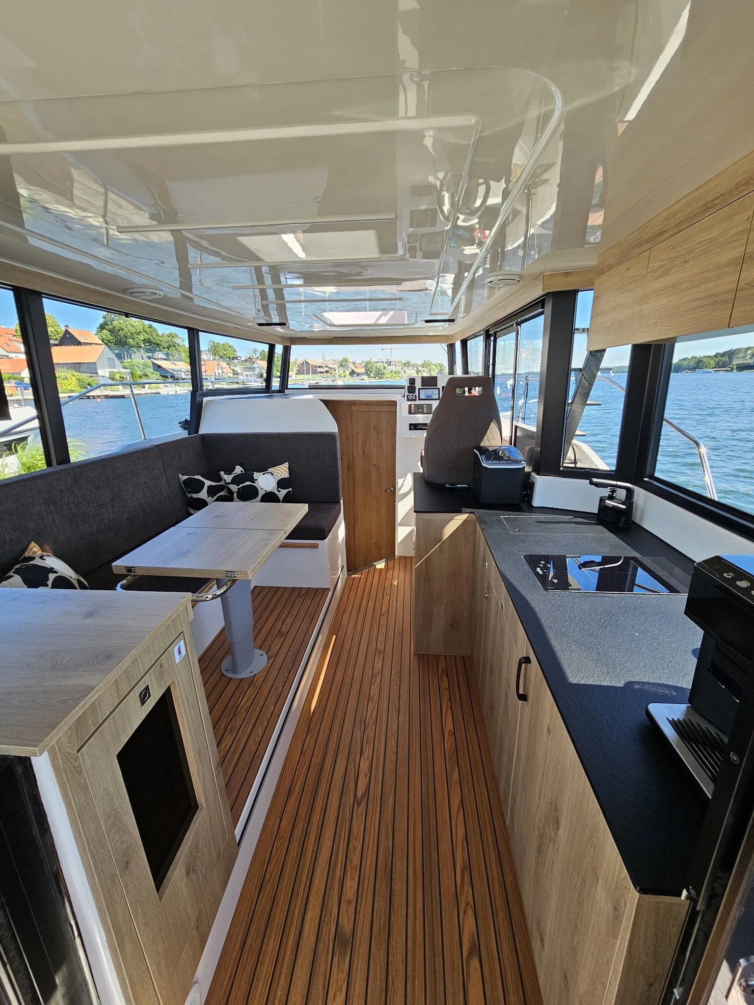 Wide interior view of the Lamdo eLY30+ showing the saloon, galley and helm station.