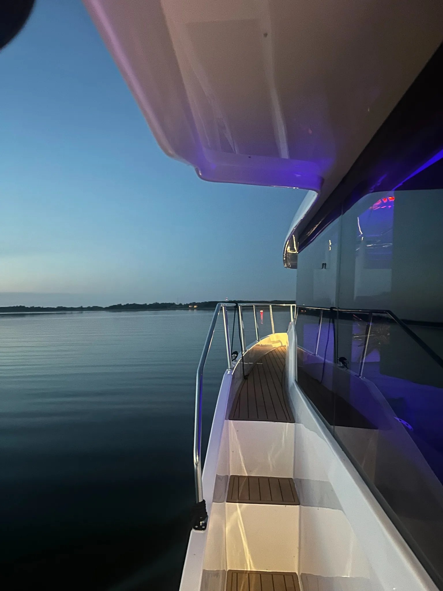 Illuminated side deck of the Lamdo eLY30+ during an evening cruise.