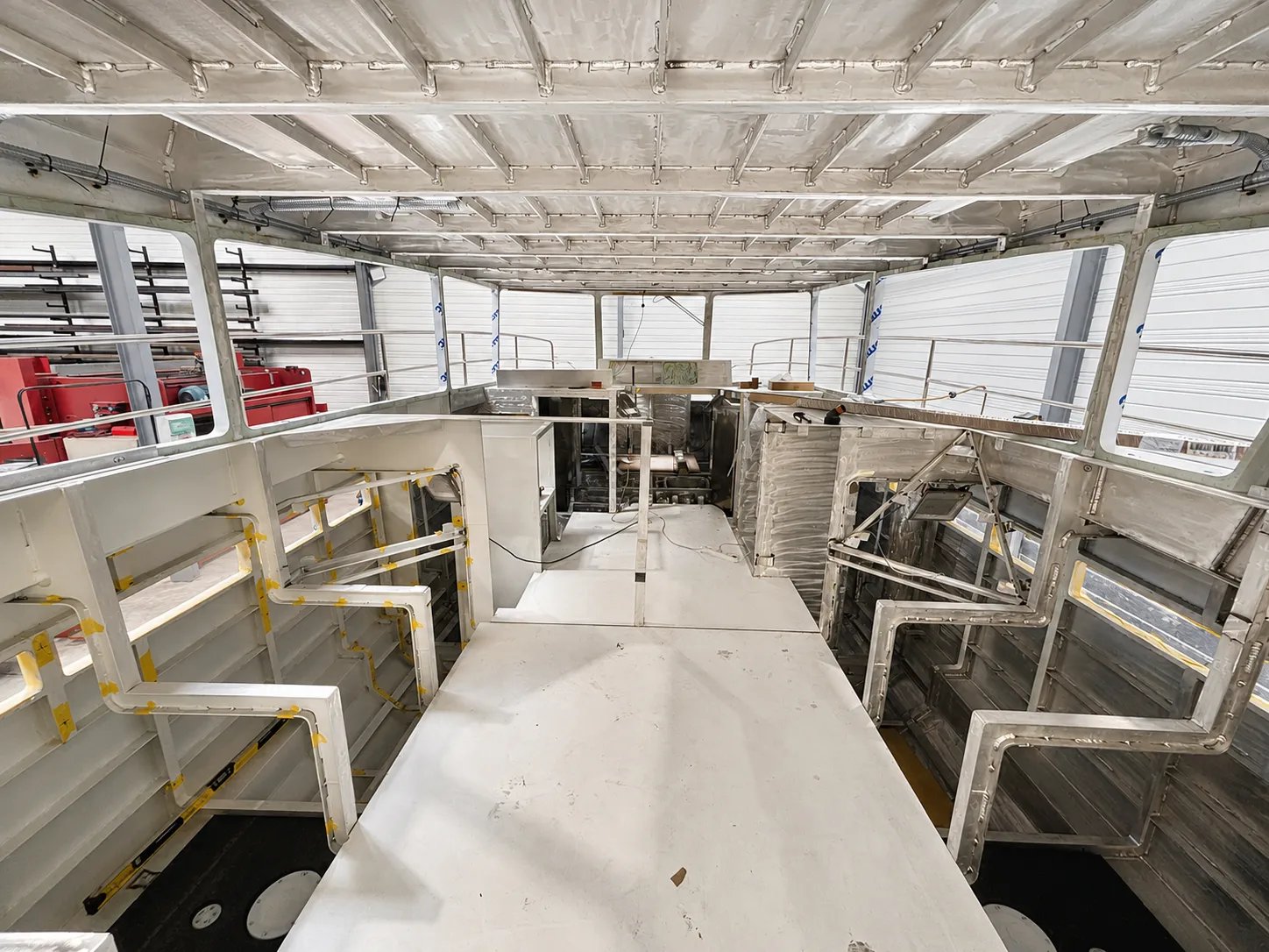 Interior of the Solann under construction, with the main deck, cabin openings and pre-installed electrical conduits.