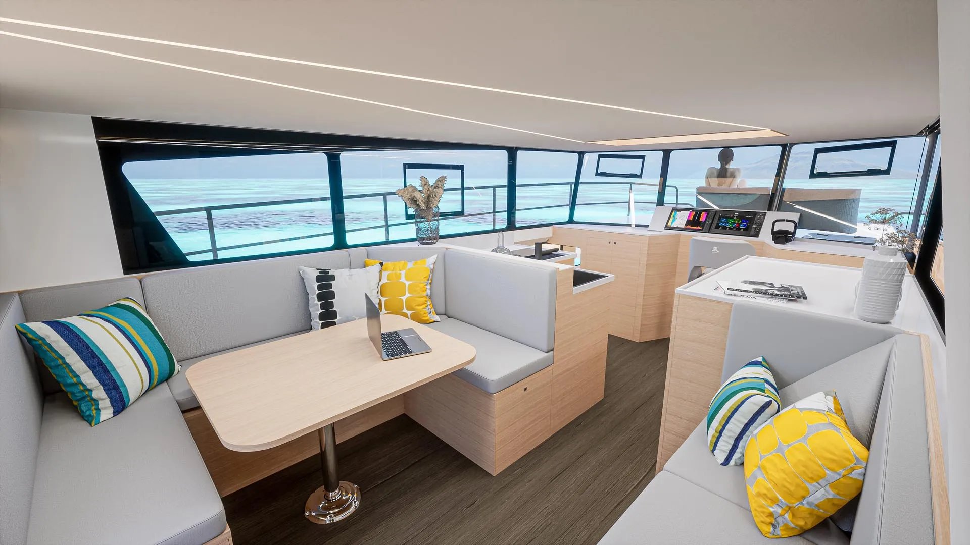 Un barco catamarán blanco y negro con una computadora portátil sobre la mesa.