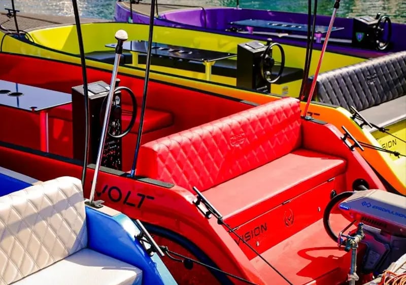 A red and yellow boat with the word Volt on the side.