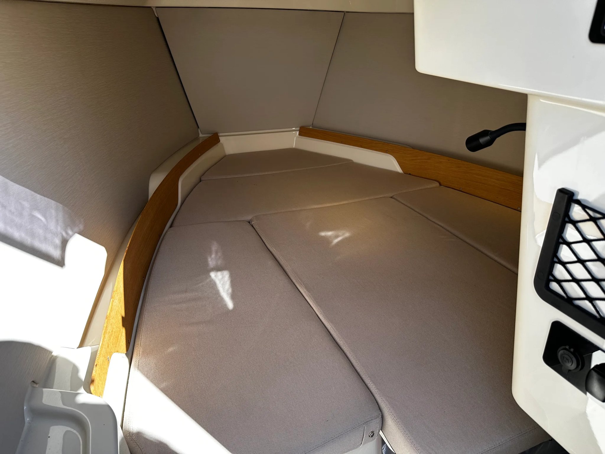 X Shore 1 Open Performance bow cabin berth with cushions and side storage