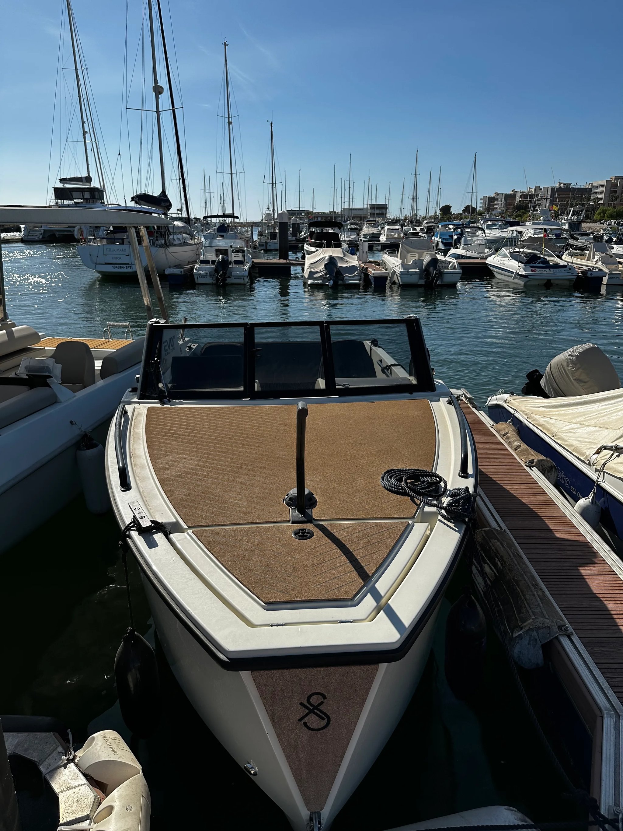 X Shore 1 Open Performance bow deck with cork flooring and marina view