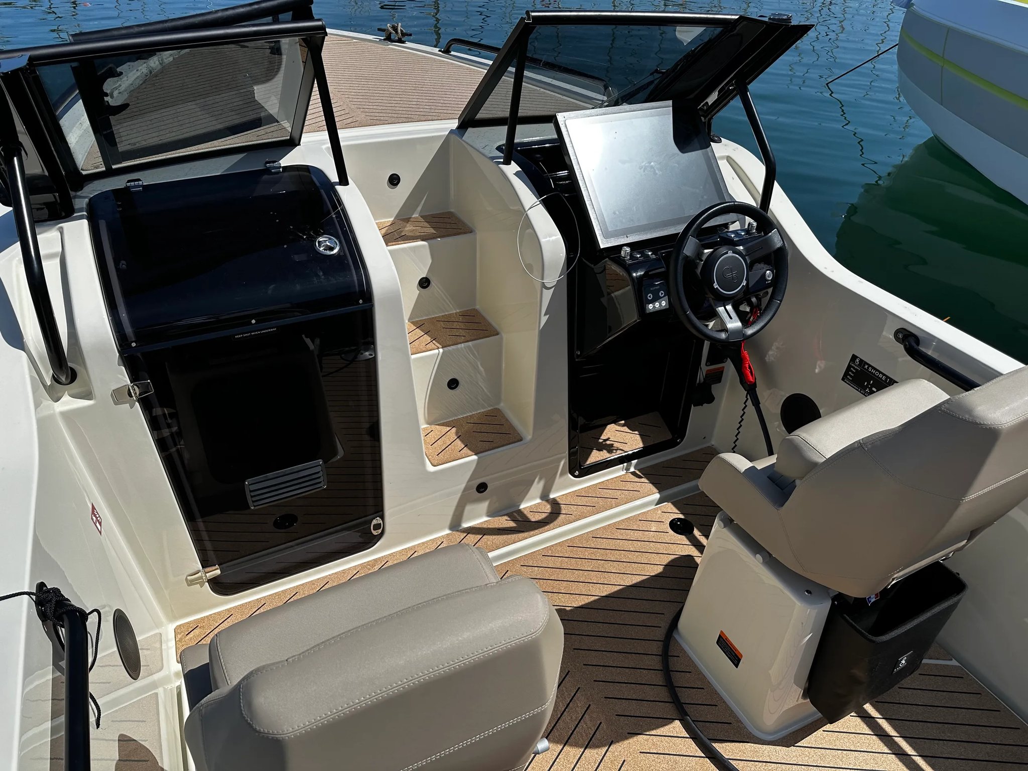 X Shore 1 Open Performance cockpit with helm, seats and bow cabin entrance