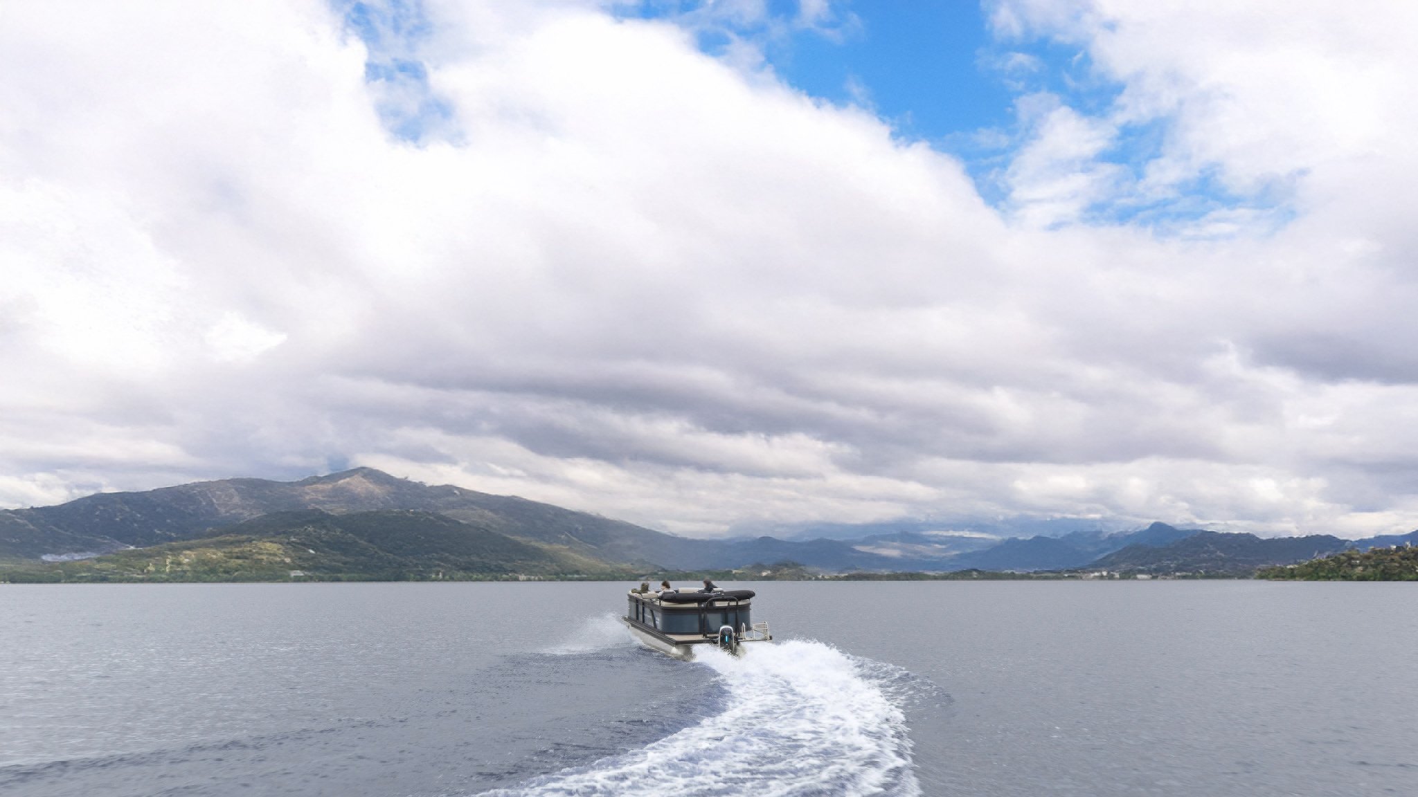 A boat with people on it is traveling on the water.