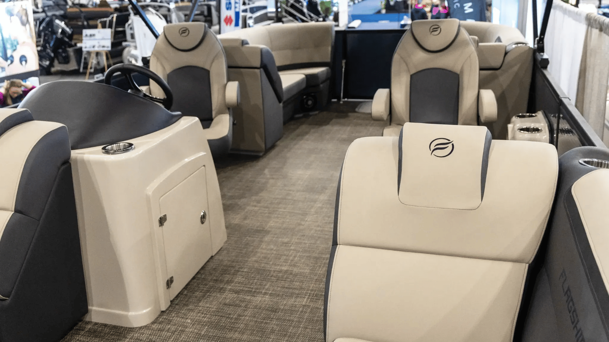 A boat with a white seat and a black steering wheel.