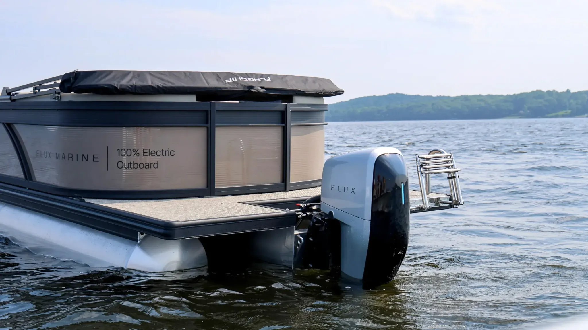 A boat with a black canopy and a sign that says 100% electric.