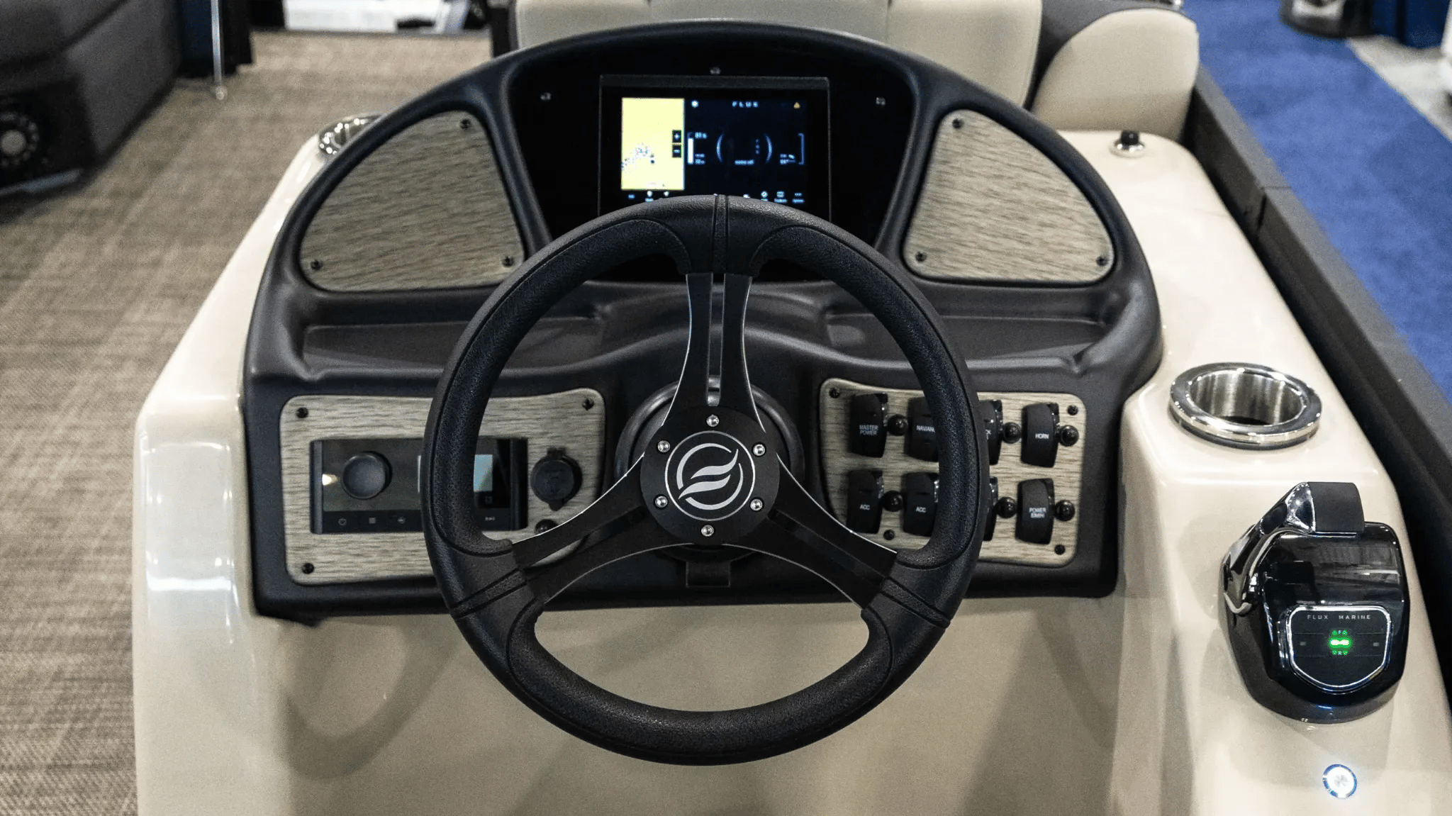 A black steering wheel on a boat.
