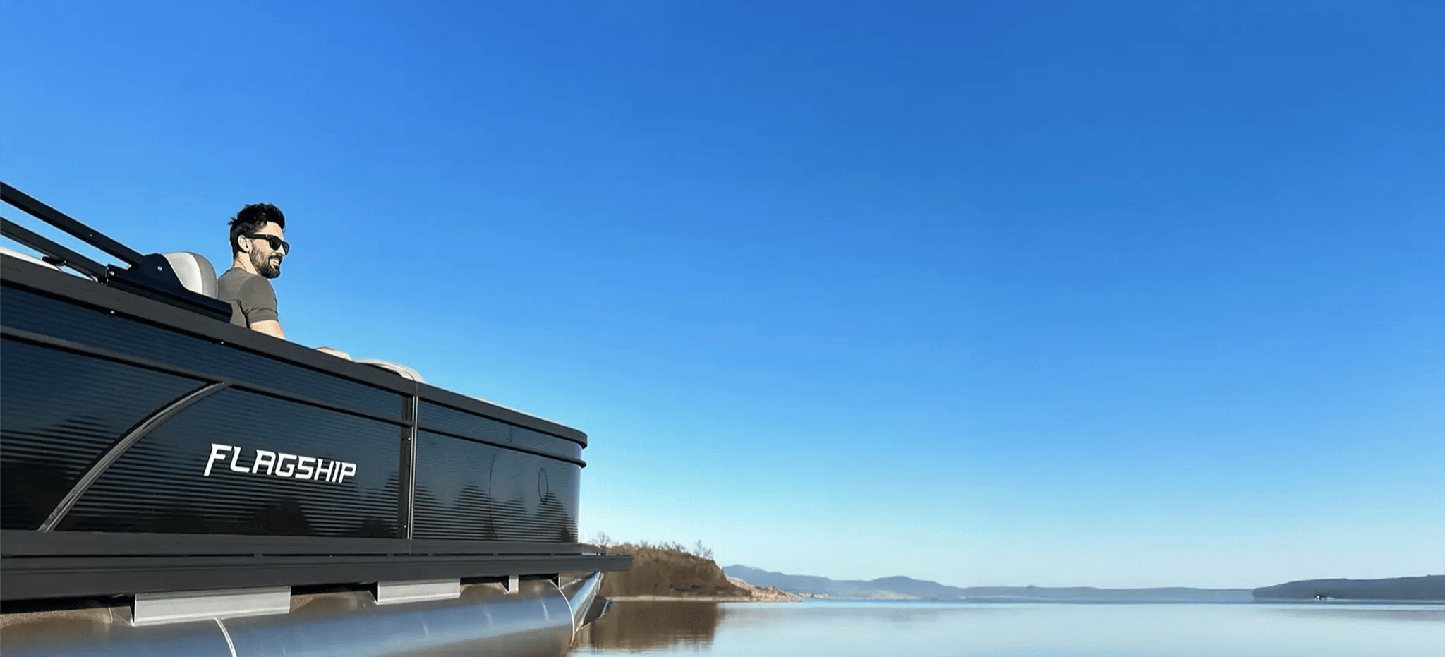 A boat on the water with a blue sky above.