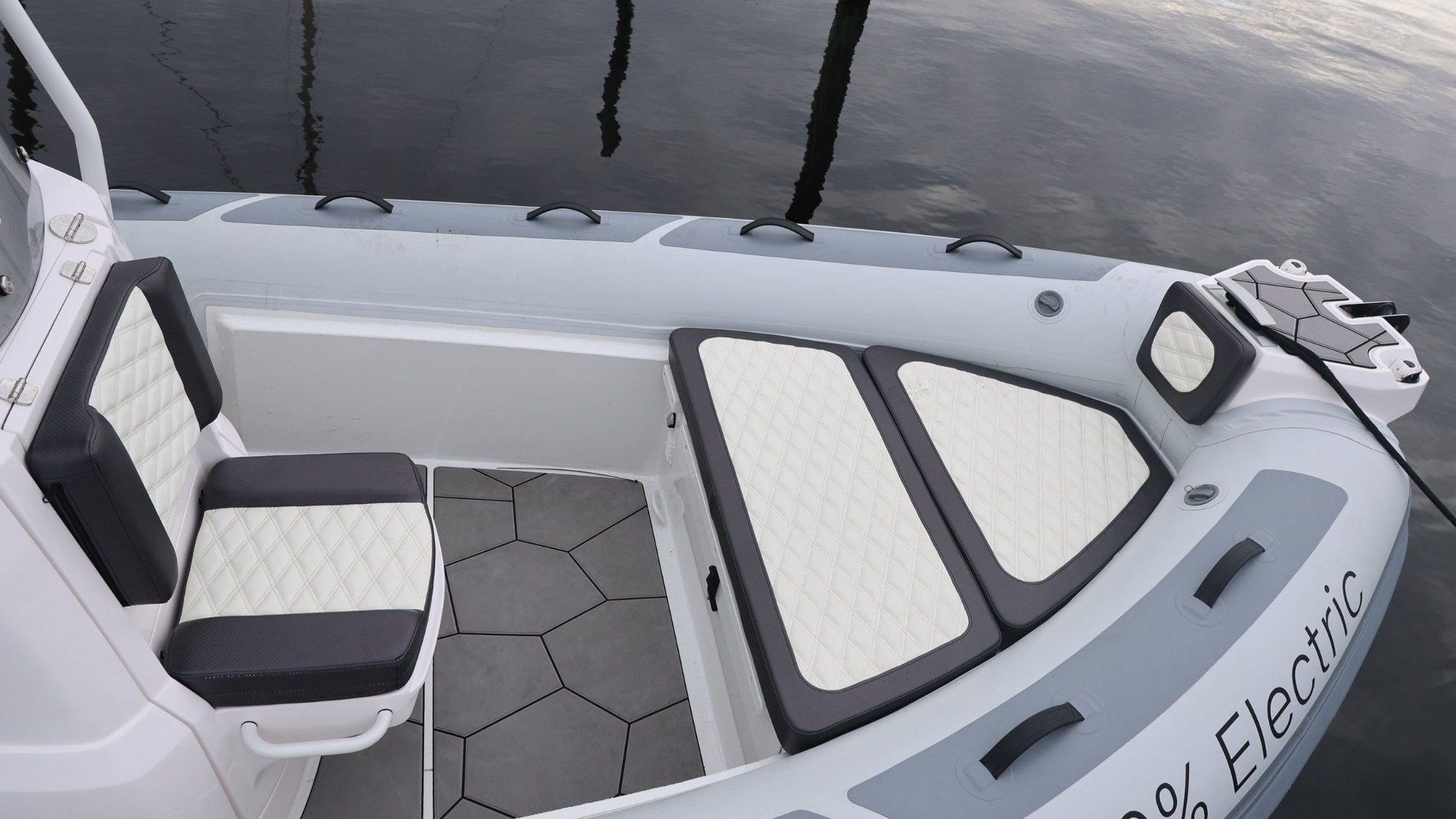 A white and gray boat with a black seat.