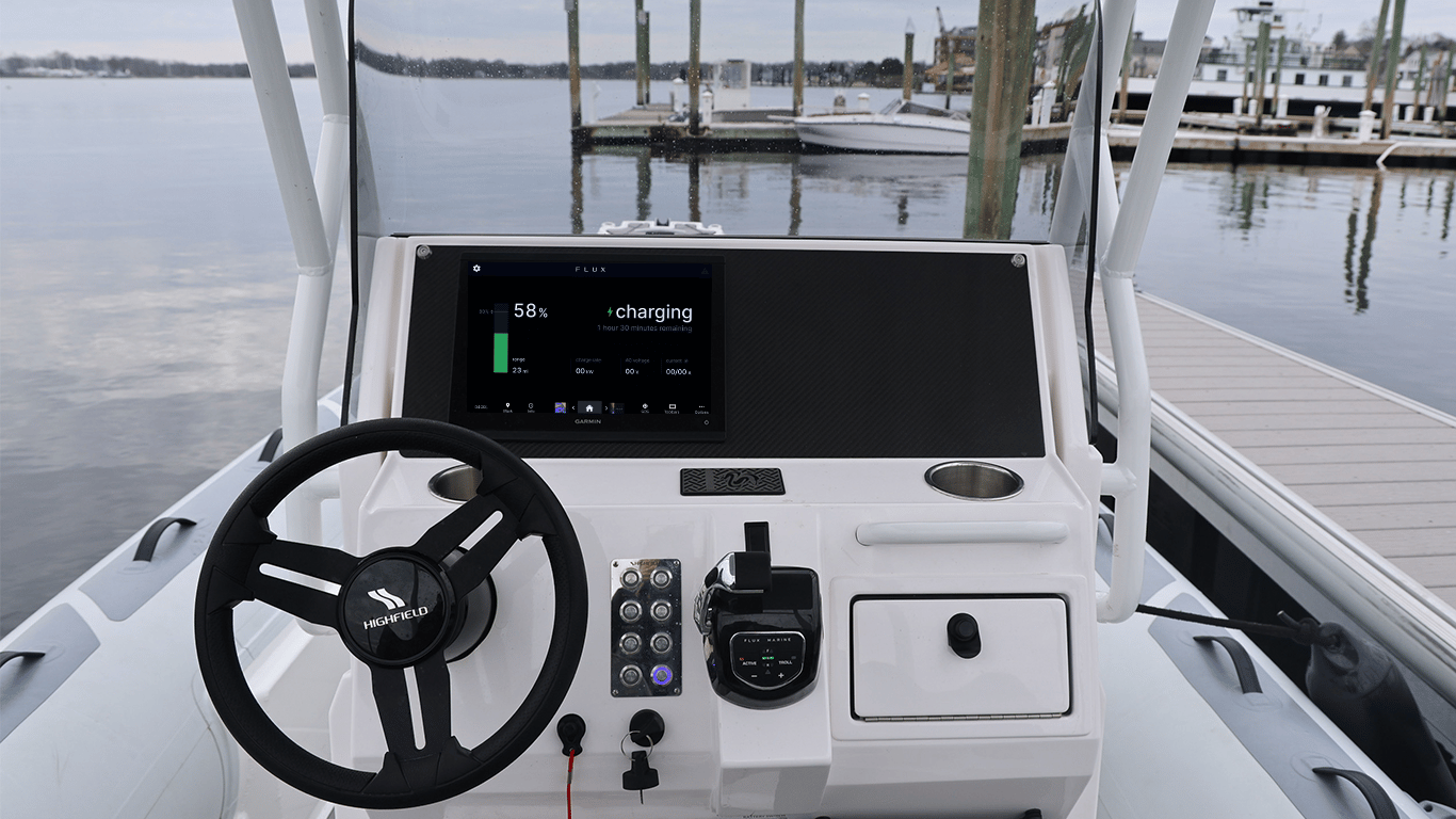 A boat with a black steering wheel and a digital display.