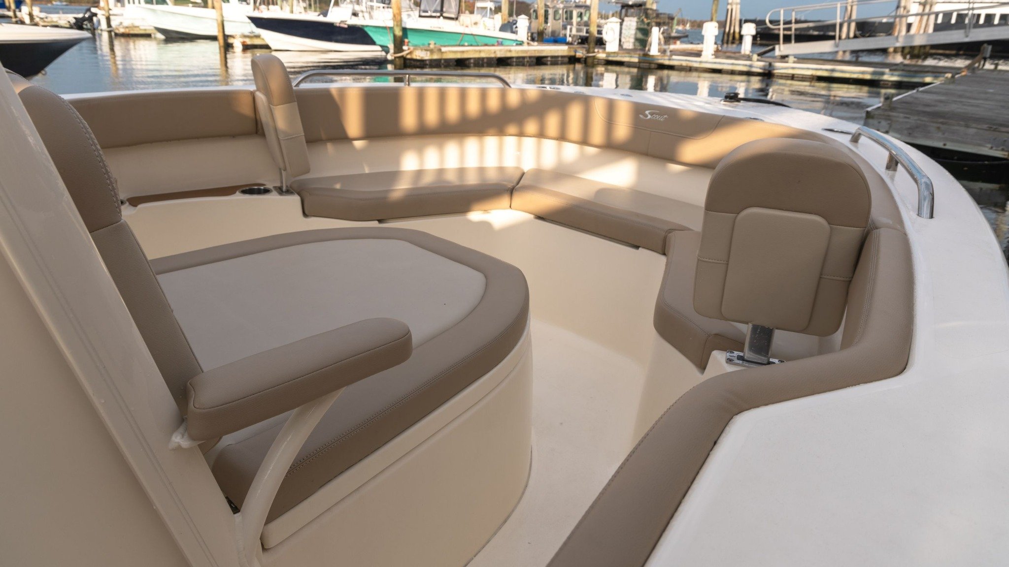 A white boat with a brown seat.