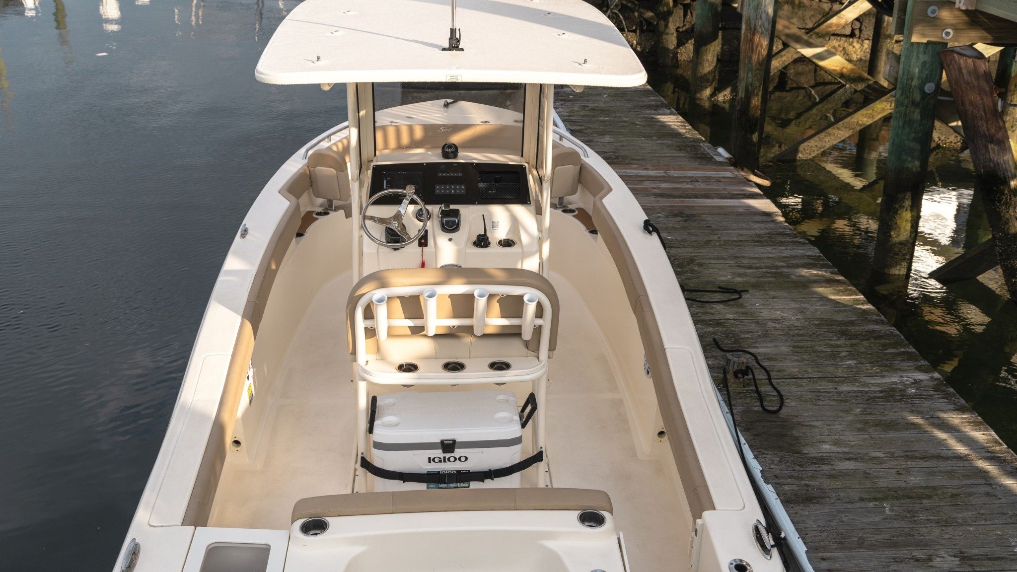 A white boat with a black top.