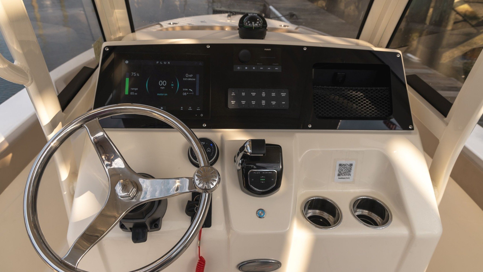 A boat with a black dashboard and a red cord.