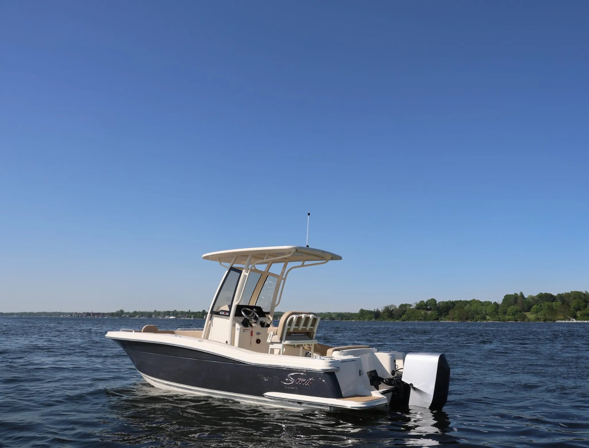 A small boat with a white top and black bottom.
